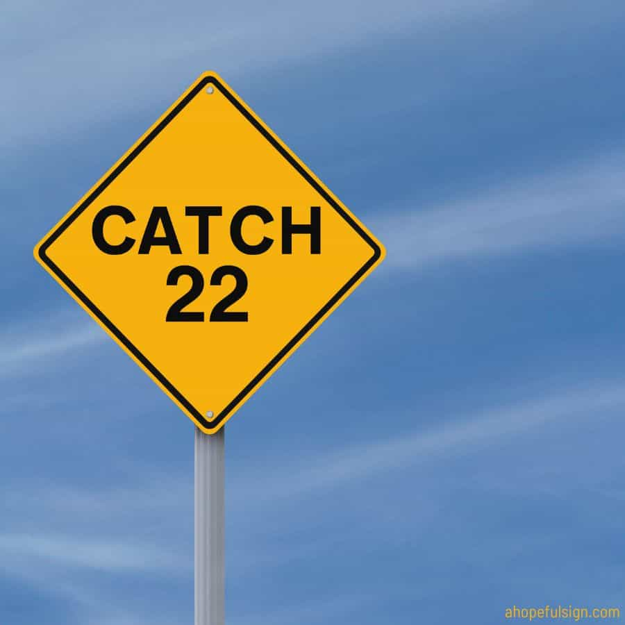 Angel number 22 meaning: A modified road sign indicating Catch 22