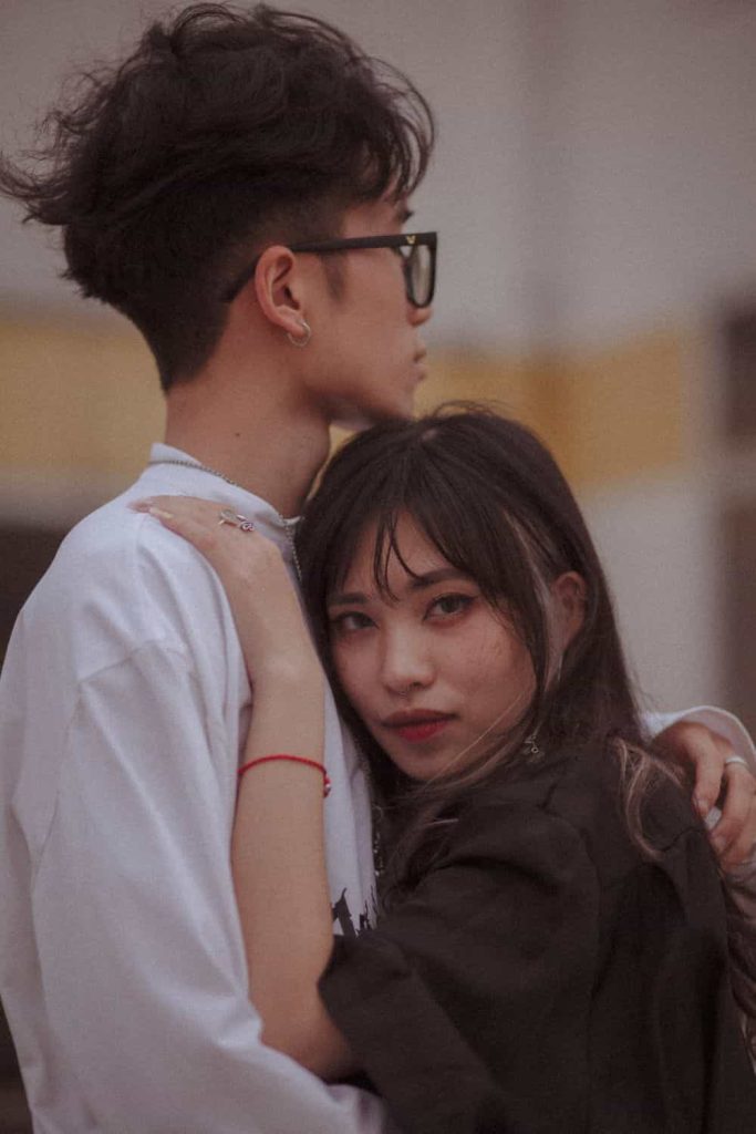 Asian man and woman hugging