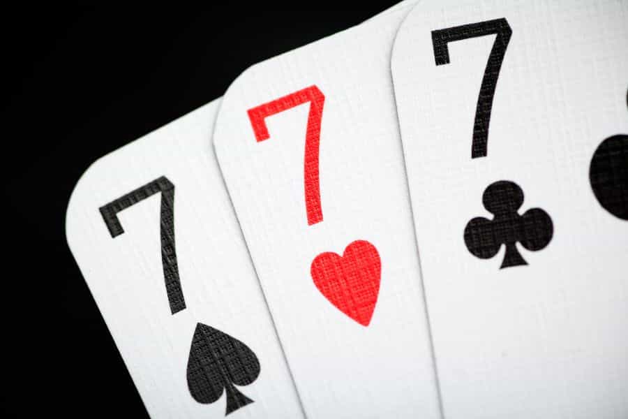 Card game hand with three cards all sevens