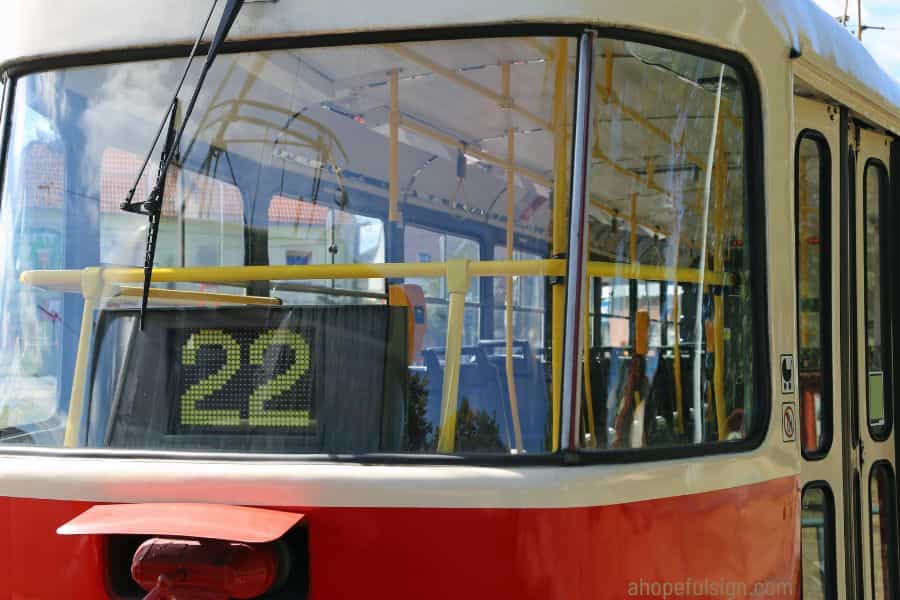 Angel number 22 meaning: Electrical tram with Number 22 i at bus stop