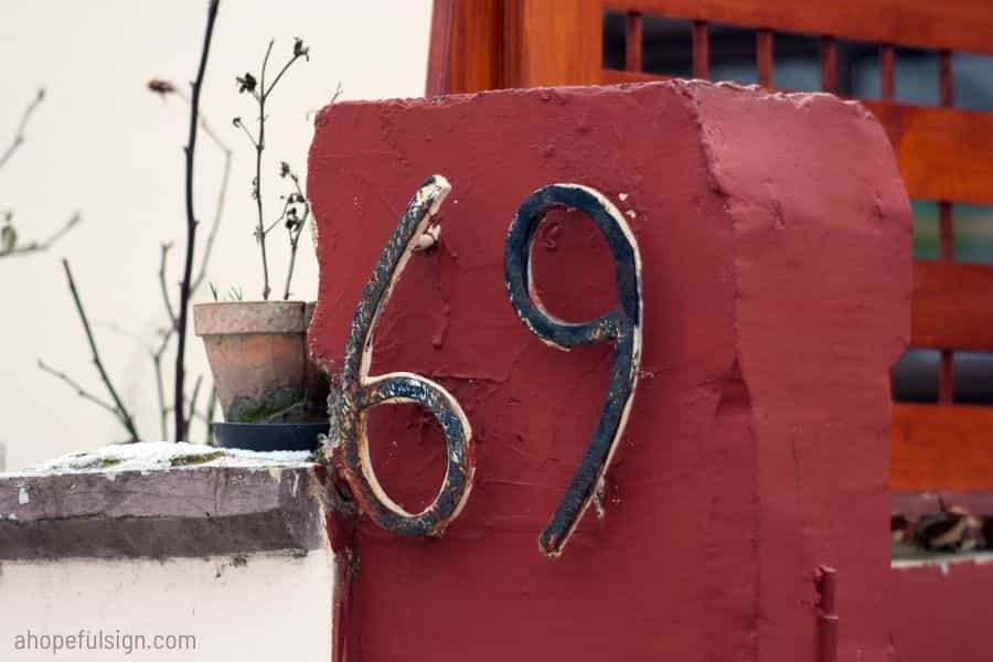 House number 69 on the old concrete fence
