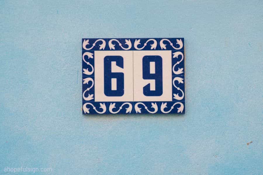 Angel number 69 meaning: House number 69 on pale blue wall