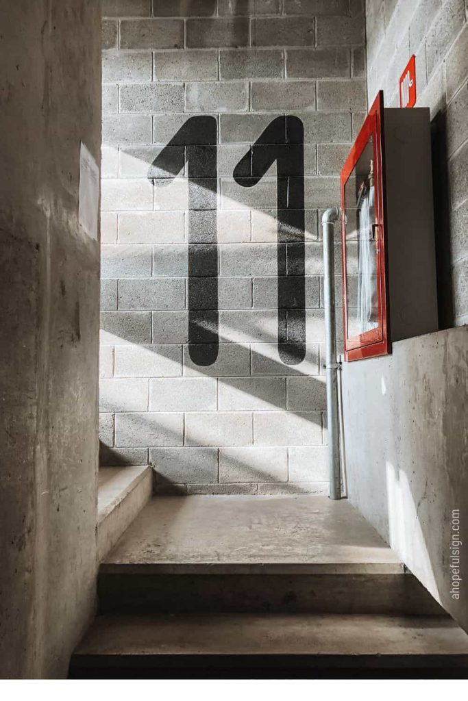 Angel number 11 meaning: 11th floor sign on stair wall