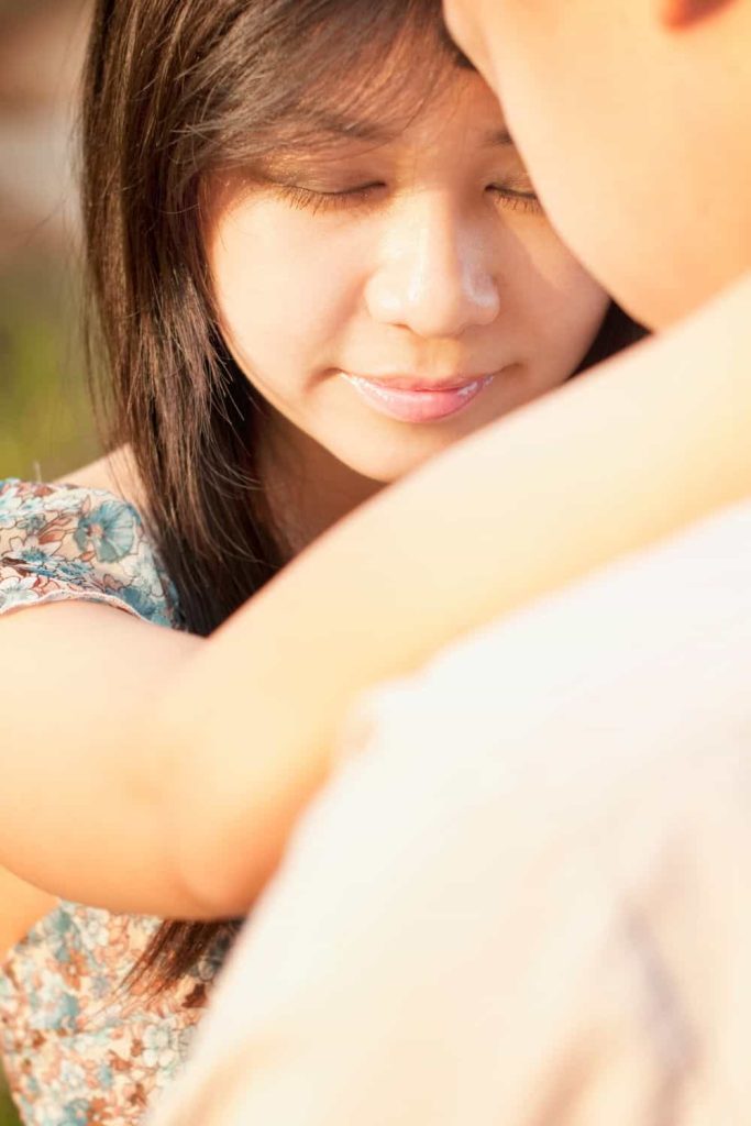 Loving Couple face to face at outdoor during sunset