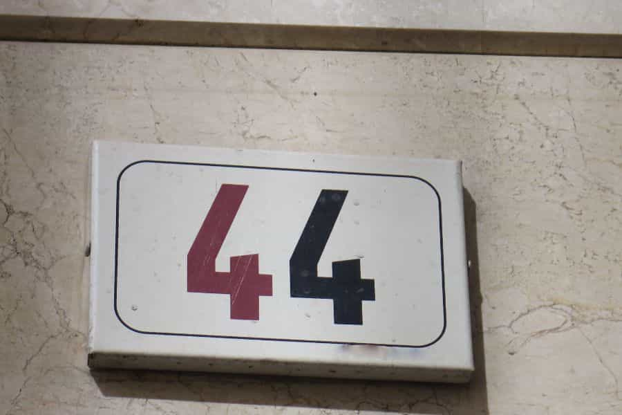 Angel number 44 meaning: Stylish house number depicting 44 in two colours