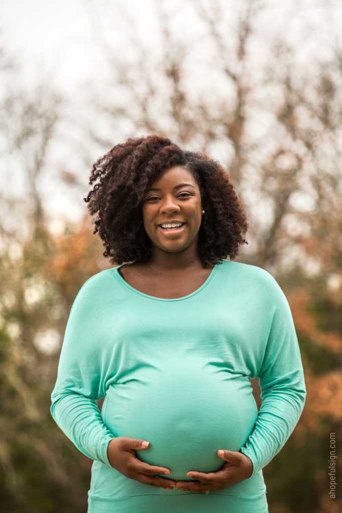 Young pregnant African American woman smiling