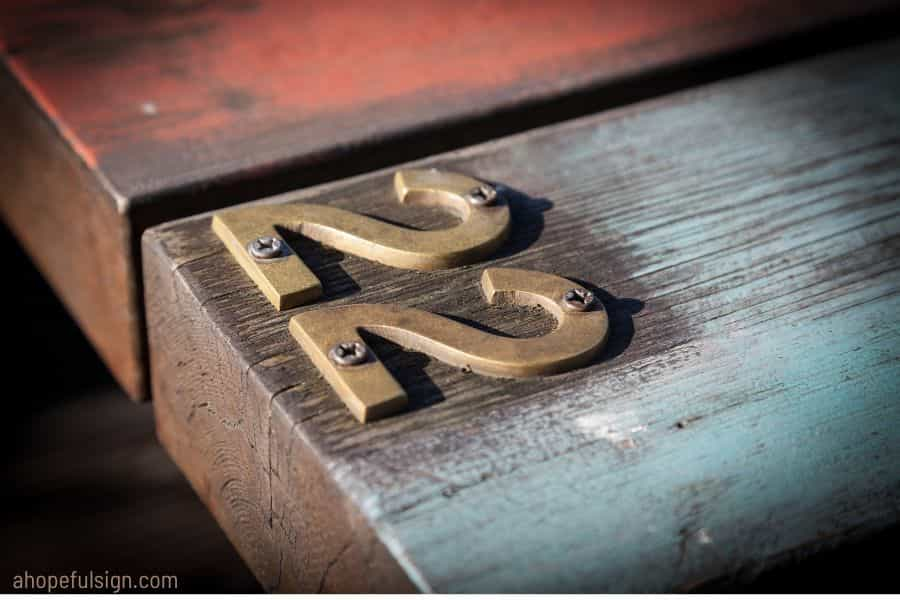 number 22, twenty-two, written in metal on a wooden table