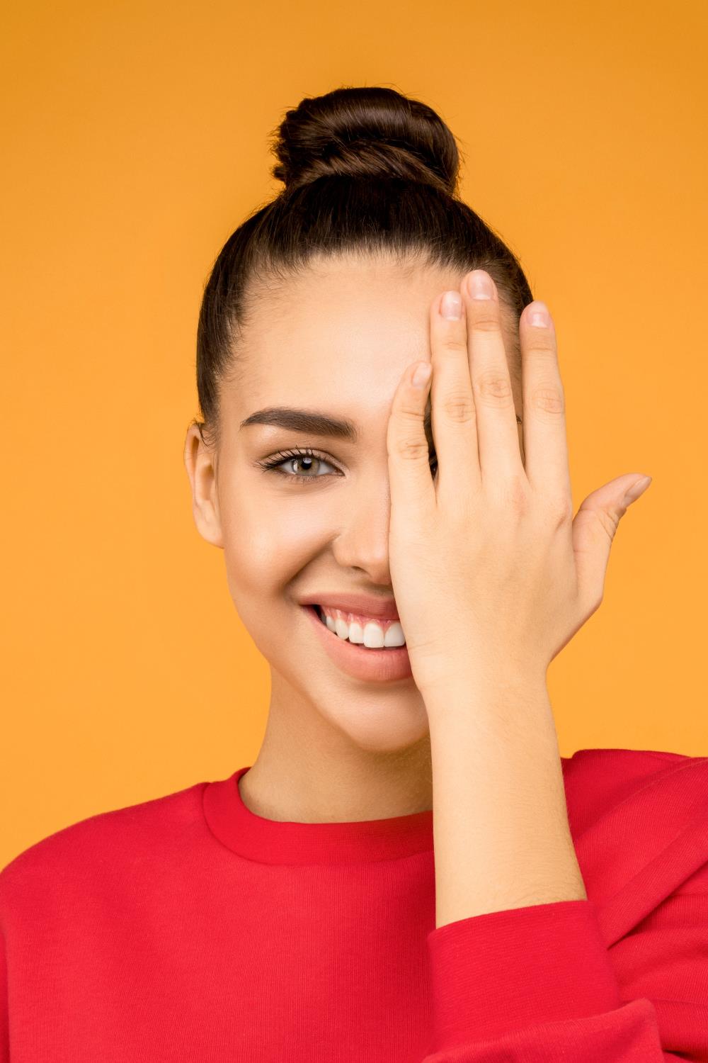 Left Eye Twitching Biblical Meaning:: Woman covering her eye with her hand